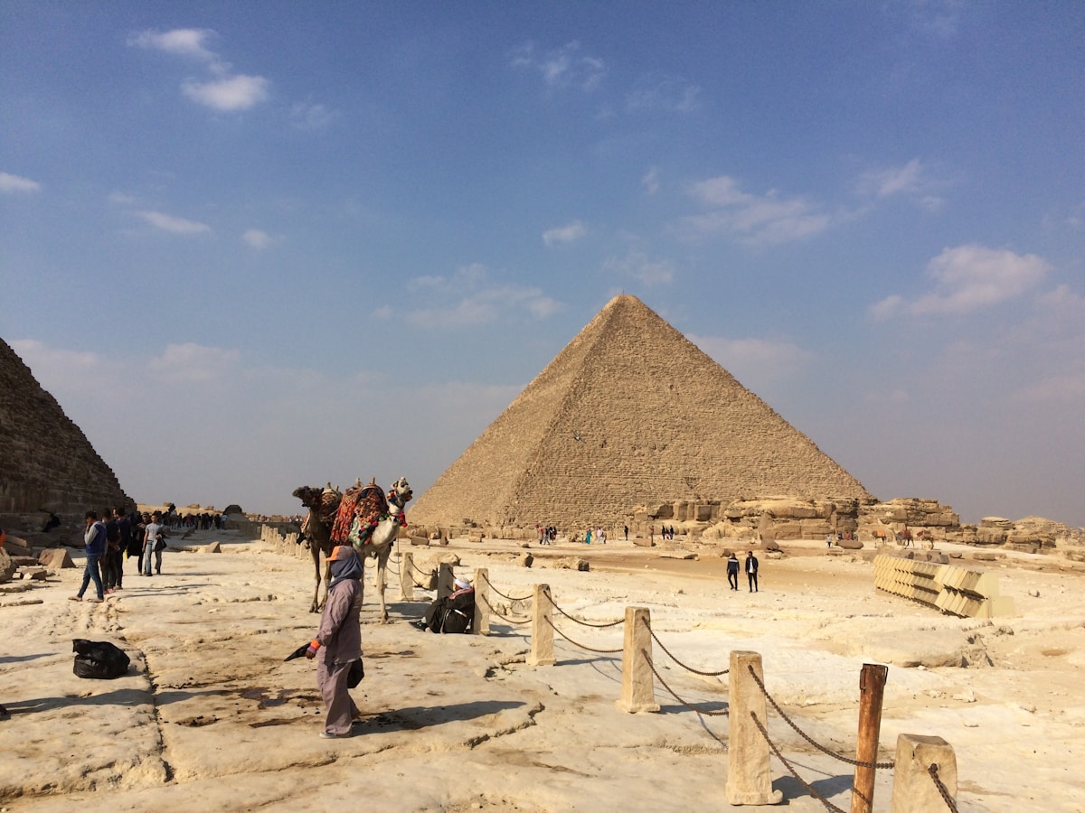 Tour group at the Giza Pyramids with the Sphinx visible in the background