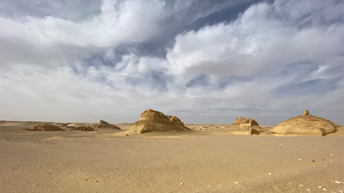 Rocky limestone formations rising from the flat desert floor at Wadi Hitan, Fayoum, Egypt
