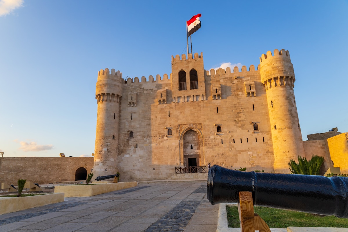 Qaitbay Citadel fortress with Egyptian flag on the Alexandria seafront, Egypt