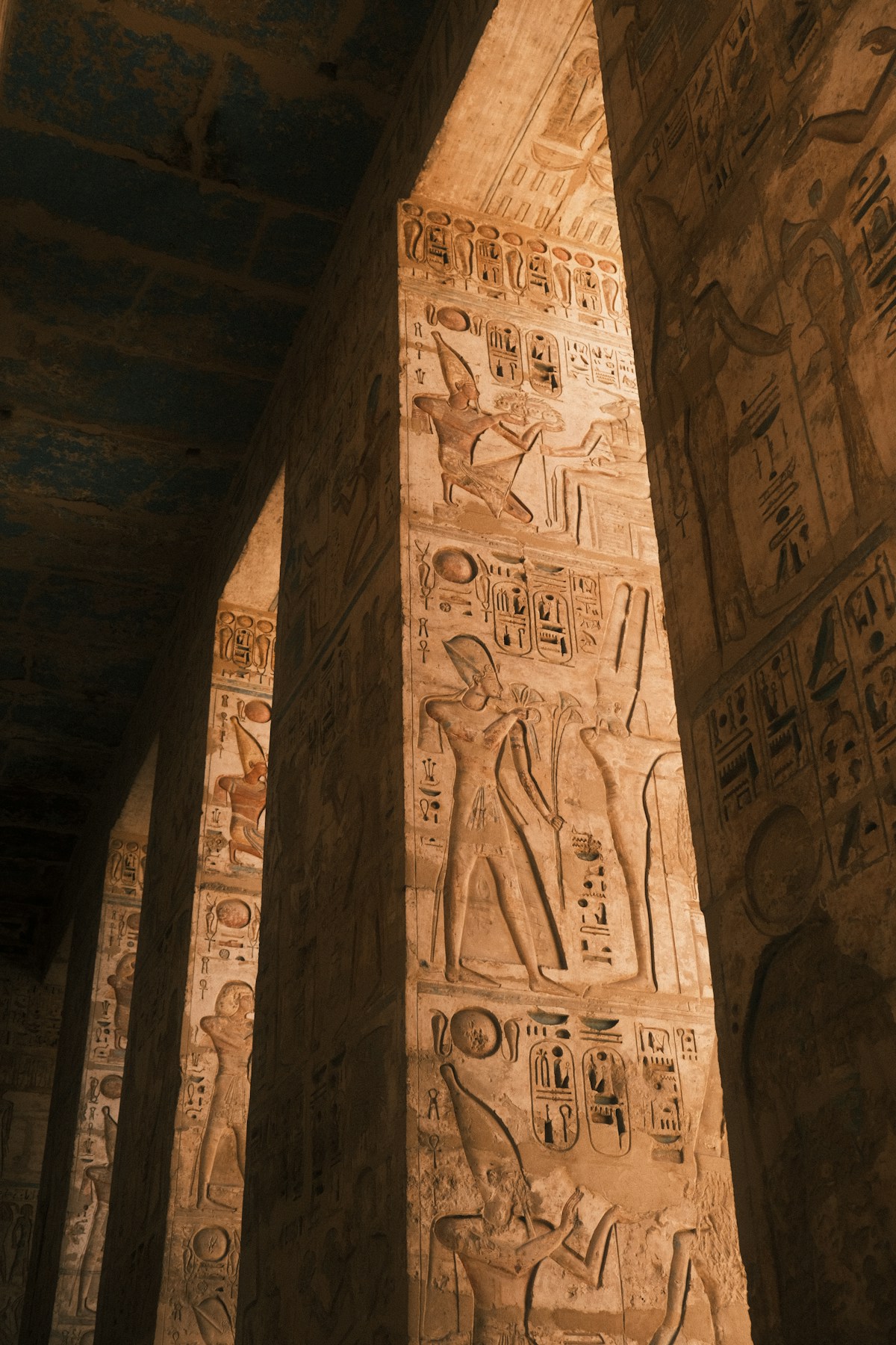 Painted tomb walls in the Valley of the Kings with hieroglyphs and vivid colours