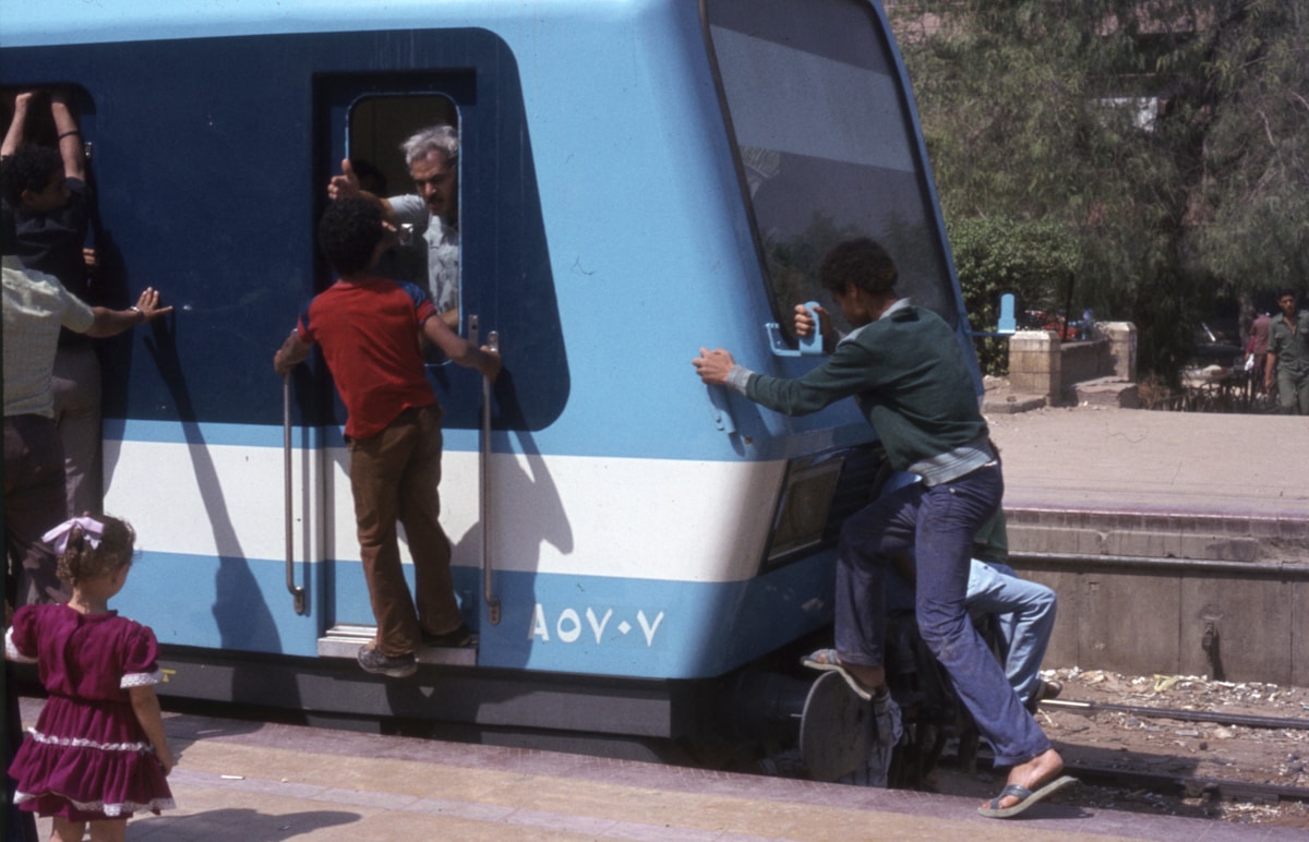 A train at Luxor station at dusk with the platform lit