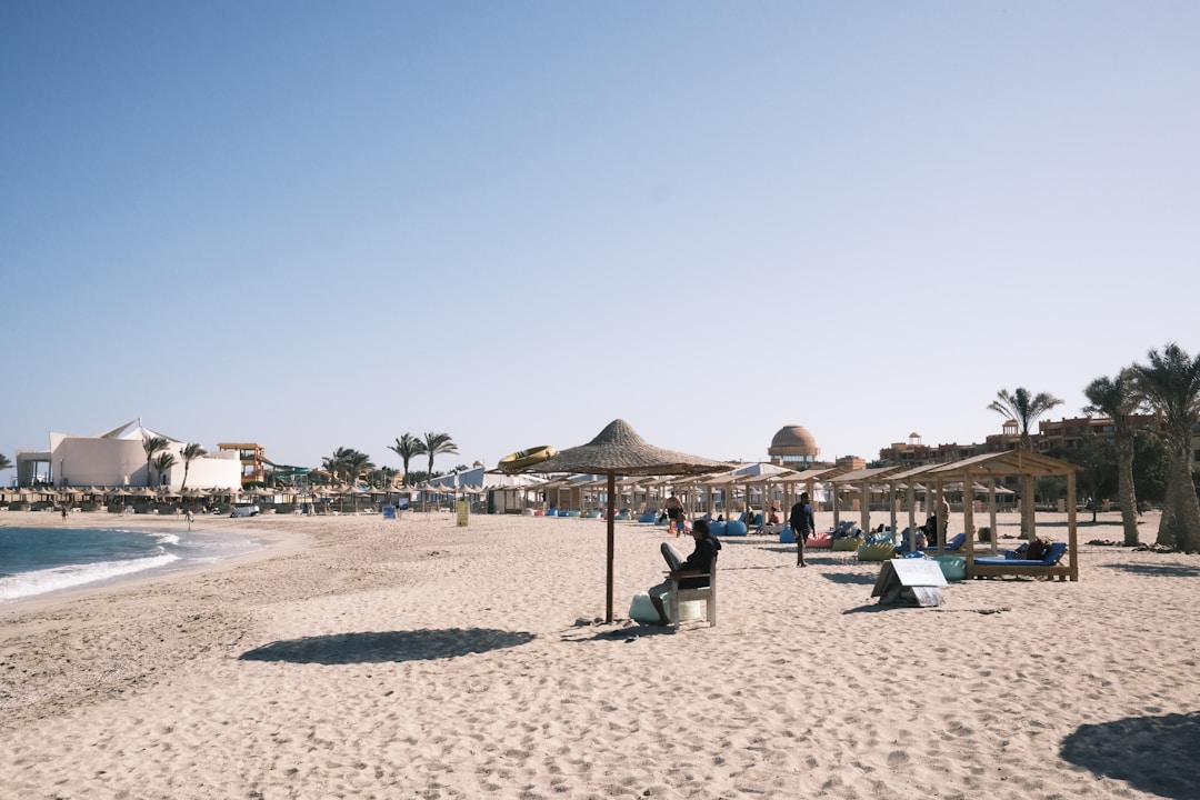 Egypt Red Sea resort beach with sun shades and loungers, tourist areas remain unaffected