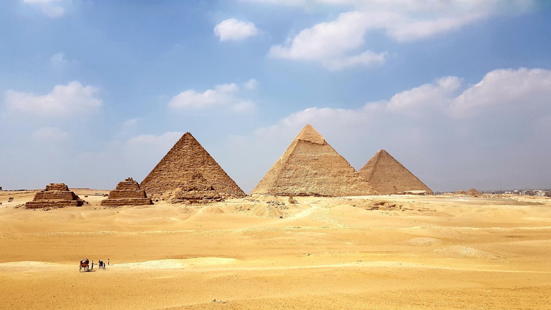 The Grand Egyptian Museum exterior with the Giza pyramids in the background