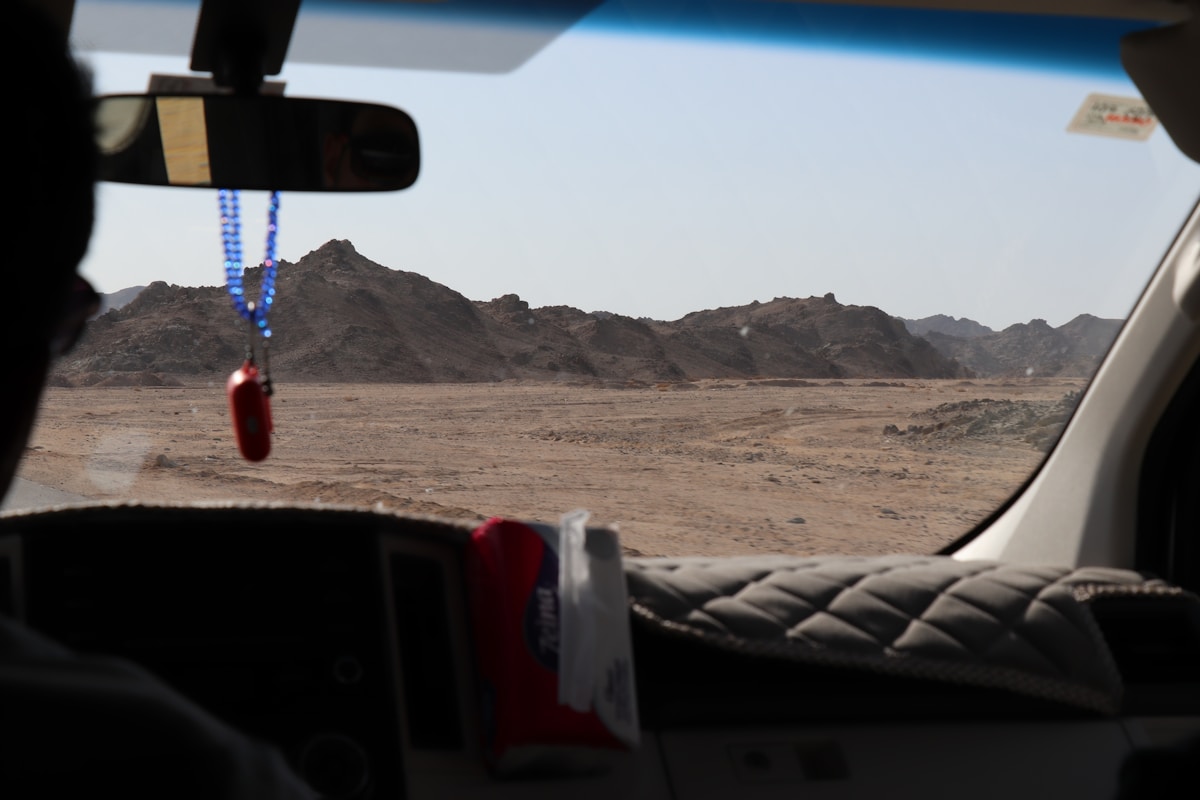 Desert landscape viewed through a car windshield, Egyptian desert road