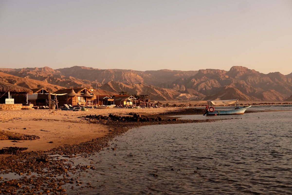 Rustic Sinai beach at sunset near Dahab with mountain backdrop, Egypt