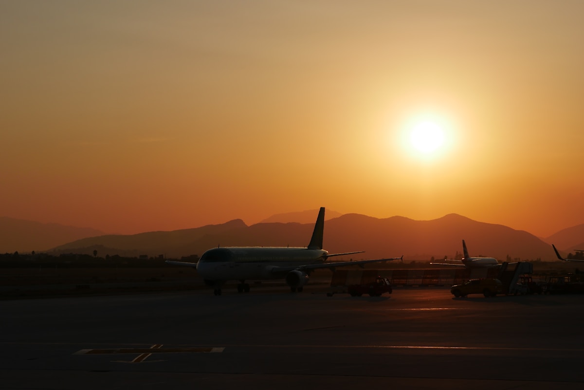 Passenger airplane on airport runway at sunset, Egypt