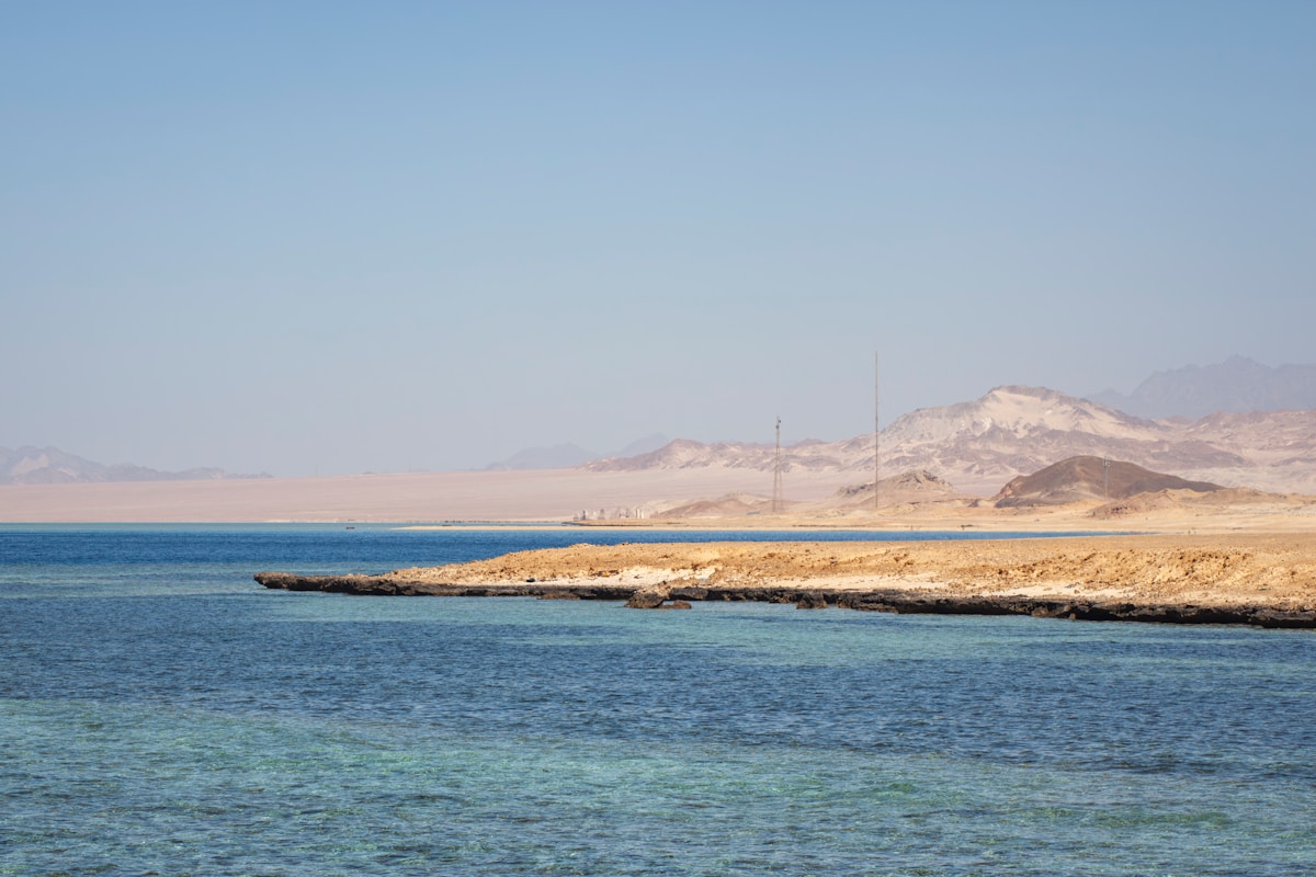 Beach chairs and umbrellas on a sun-drenched Red Sea resort beach in Egypt