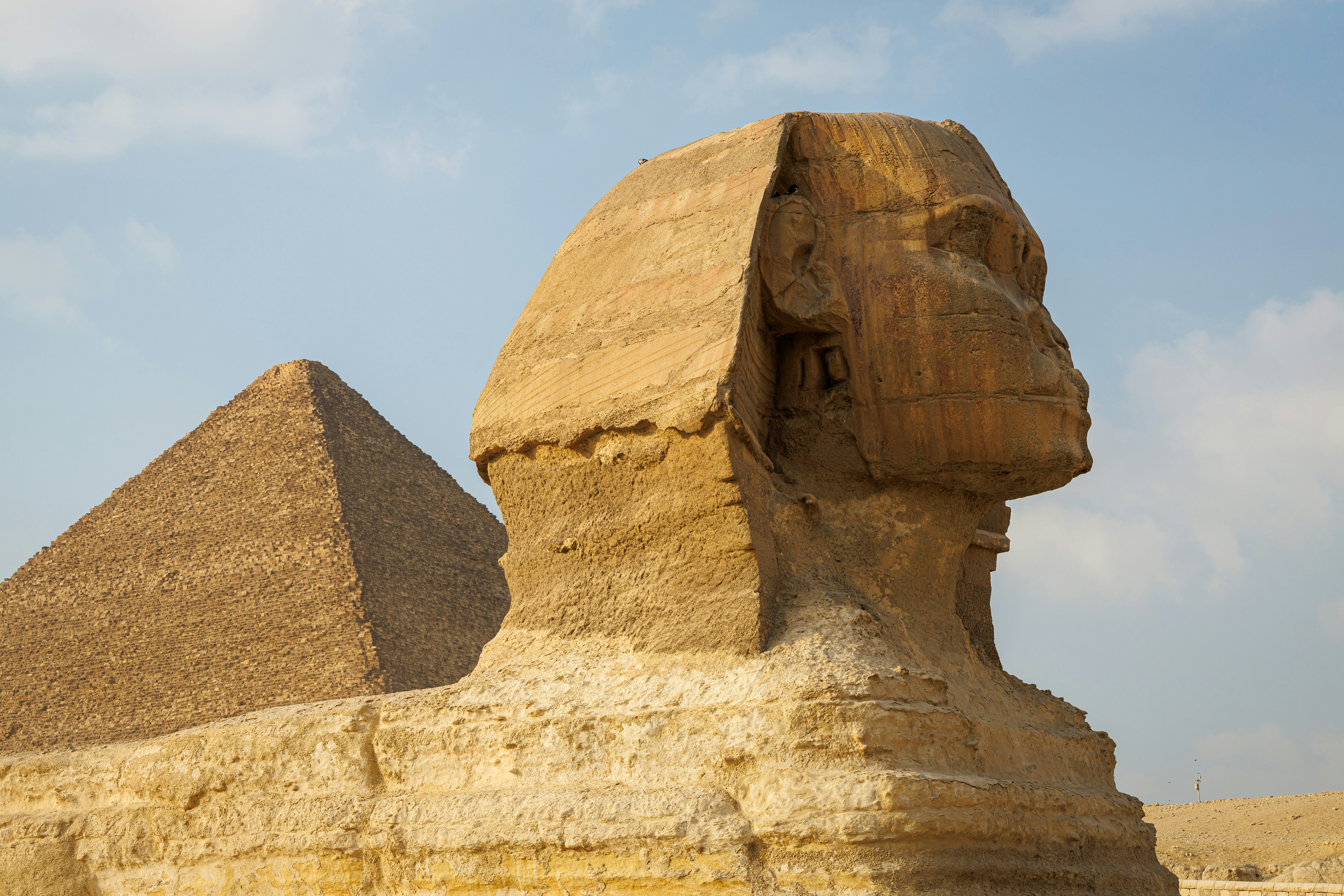 The Great Sphinx of Giza with the Pyramid of Khafre rising behind it