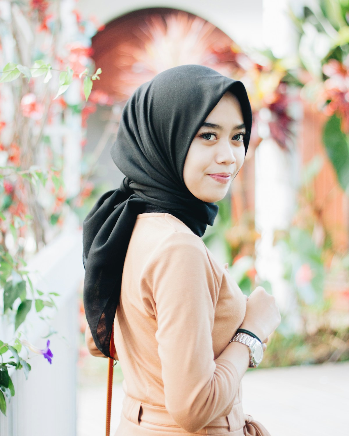 Woman in black hijab and modest tan clothing — appropriate dress for travel in Egypt