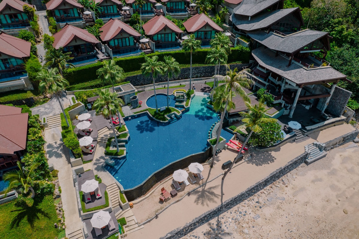 Aerial view of a Red Sea beach resort with pool and lounge chairs, Marsa Alam